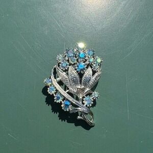 Vintage costume silver and blue gem floral brooch